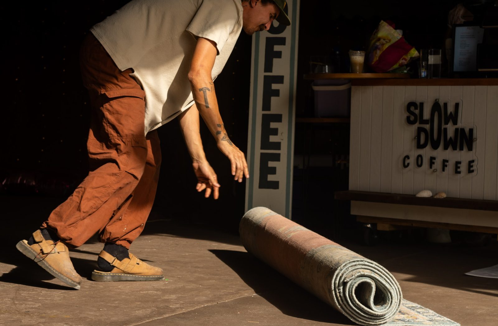 Rolling out a rug beside the Slow Down Coffee cart